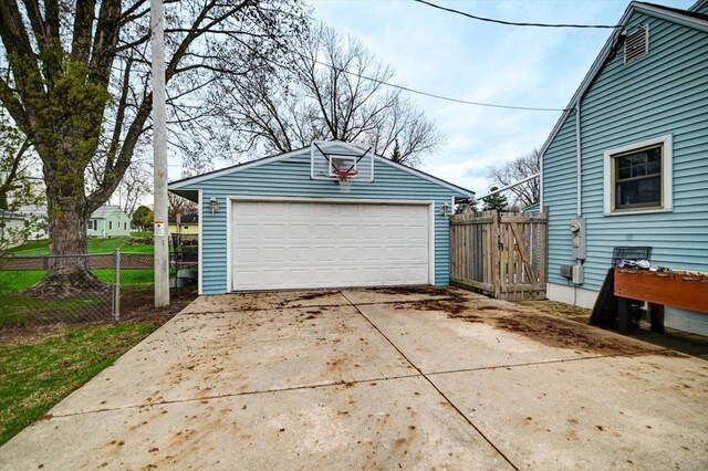detached garage featuring fence