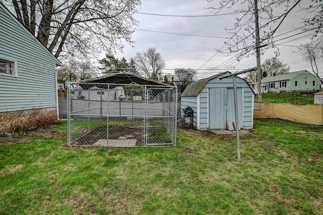 view of yard featuring fence, an outdoor structure, and a shed