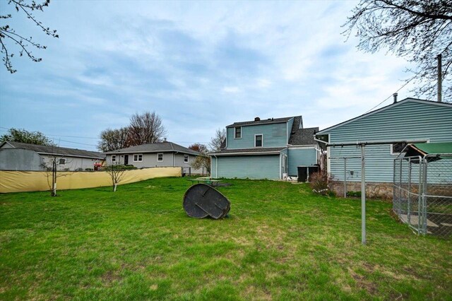 view of yard featuring fence and cooling unit