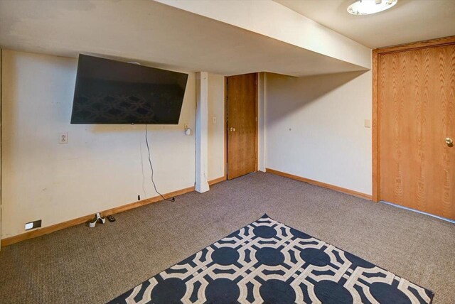 interior space with baseboards and carpet