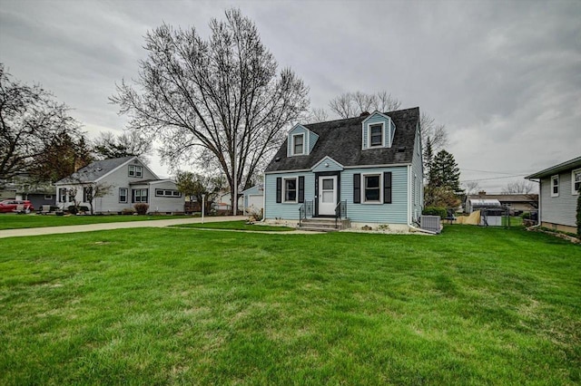 cape cod home featuring central AC unit and a front yard