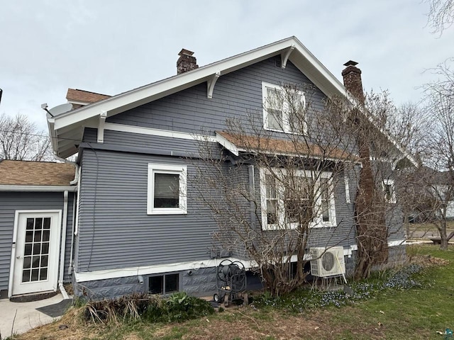 723 9th Ave W, Ashland, WI 54806 - view of home's exterior featuring a chimney and ac unit