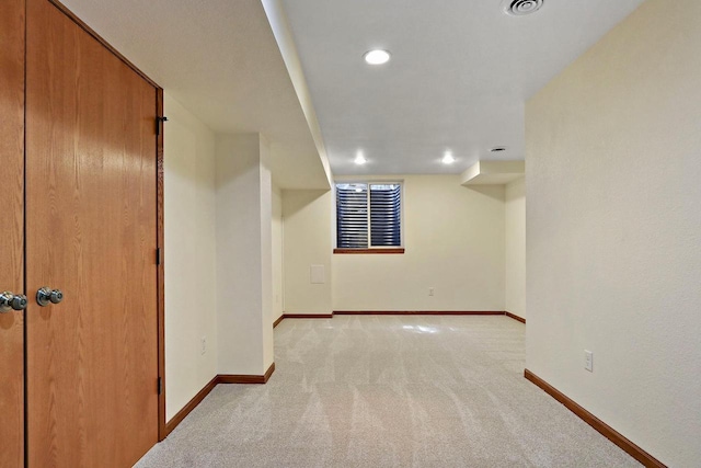 finished basement with recessed lighting, visible vents, light colored carpet, and baseboards