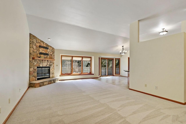 unfurnished living room featuring baseboards, an inviting chandelier, and carpet