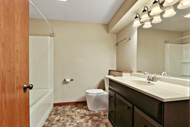 full bath featuring vanity, toilet, stone finish floor, baseboards, and shower / washtub combination
