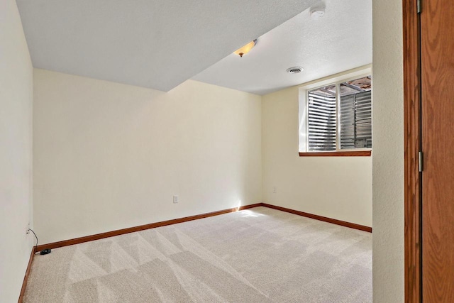 carpeted empty room with baseboards and visible vents