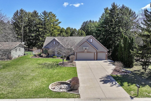 traditional-style home with a front yard, concrete driveway, and a garage