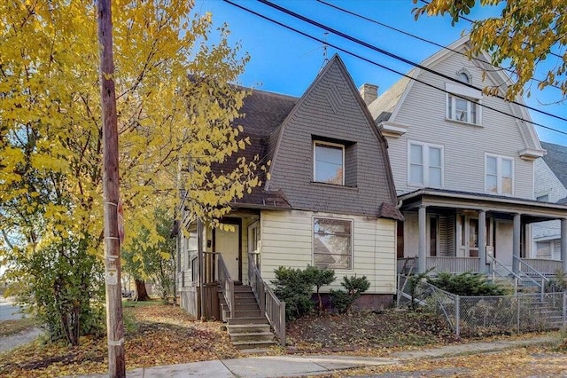 3701 W Kilbourn Ave, Milwaukee, WI 53208 - view of front of property featuring a chimney, a shingled roof, covered porch, a gambrel roof, and fence private yard