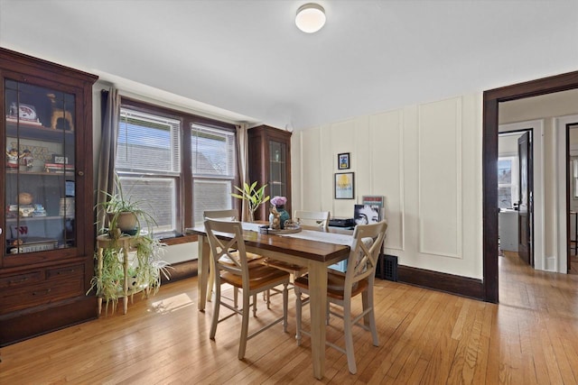 dining space with light wood-type flooring
