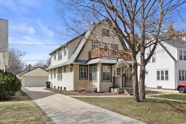 dutch colonial featuring a garage, a balcony, a shingled roof, and an outbuilding