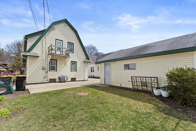 rear view of house with a balcony, a patio area, a yard, a gambrel roof, and central AC