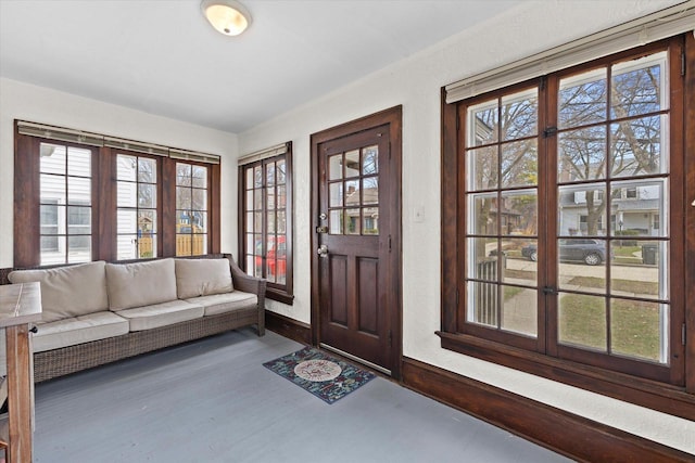 interior space with baseboards, wood finished floors, and a healthy amount of sunlight