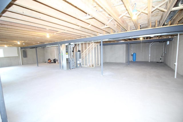 unfinished basement with heating unit and gas water heater