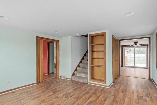 interior space featuring stairs, visible vents, baseboards, and light wood-type flooring