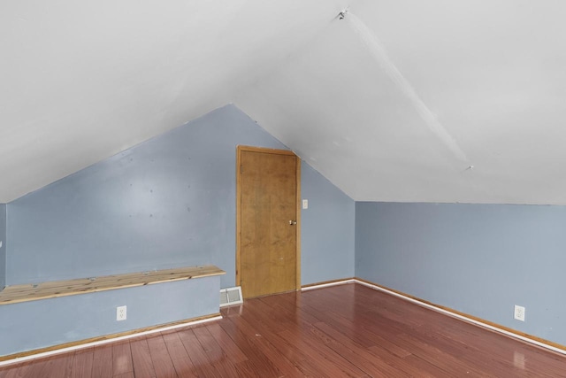 bonus room featuring baseboards, wood finished floors, and lofted ceiling