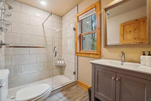37475 Sophie Ln, Bayfield, WI 54814 - bathroom with vanity, toilet, a shower stall, and baseboards
