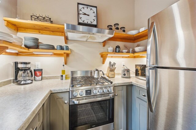 37475 Sophie Ln, Bayfield, WI 54814 - kitchen with ventilation hood, gray cabinets, open shelves, and appliances with stainless steel finishes