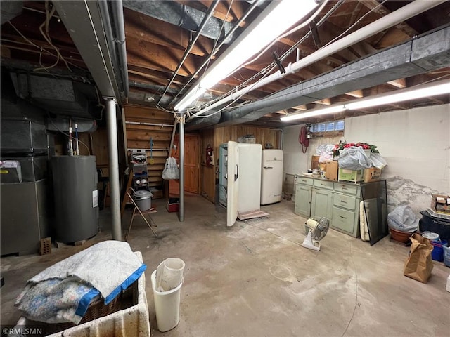 318 2nd Ave, Milltown, WI 54858 - unfinished below grade area featuring heating unit, freestanding refrigerator, and electric water heater