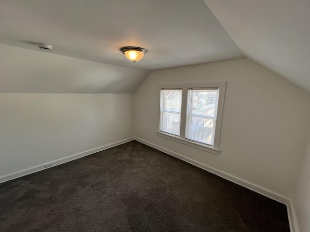 4631 N 37th St, Milwaukee, WI 53209 - additional living space featuring baseboards, dark colored carpet, and lofted ceiling