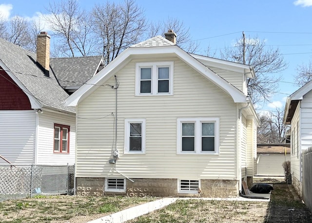 4631 N 37th St, Milwaukee, WI 53209 - back of property featuring fence, a chimney, and roof with shingles