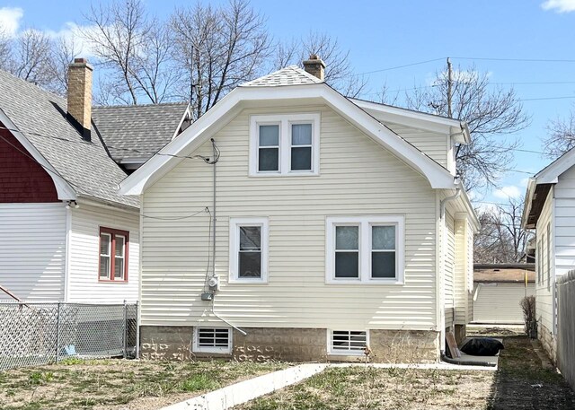 4631 N 37th St, Milwaukee, WI 53209 - back of property featuring fence, a chimney, and roof with shingles