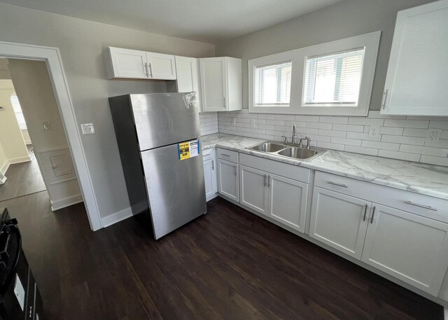 4631 N 37th St, Milwaukee, WI 53209 - kitchen featuring dark wood-style flooring, a sink, freestanding refrigerator, white cabinetry, and tasteful backsplash
