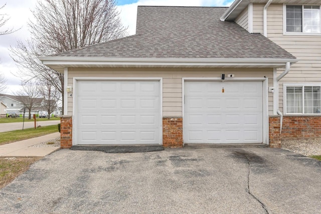 garage featuring aphalt driveway