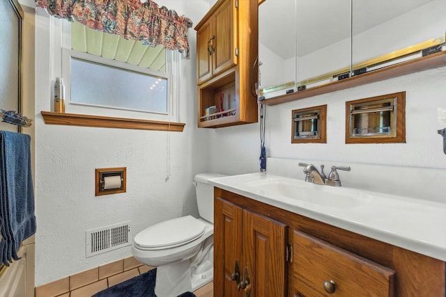 bathroom featuring tile patterned floors, visible vents, toilet, and vanity