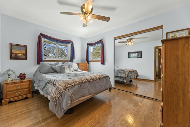 bedroom featuring ceiling fan, a closet, and light wood finished floors