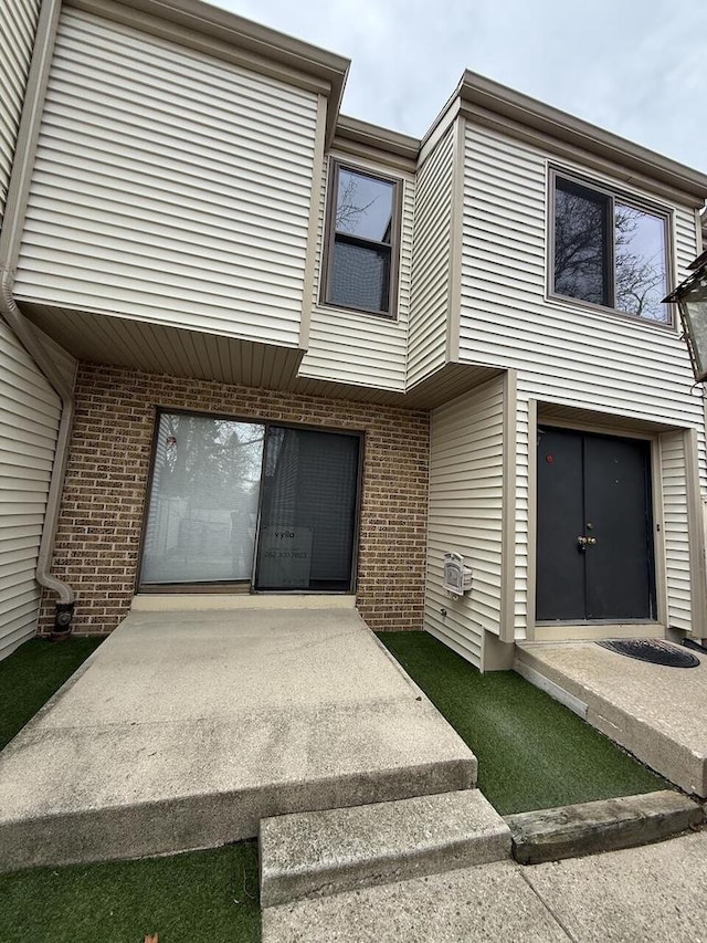 view of property featuring brick siding