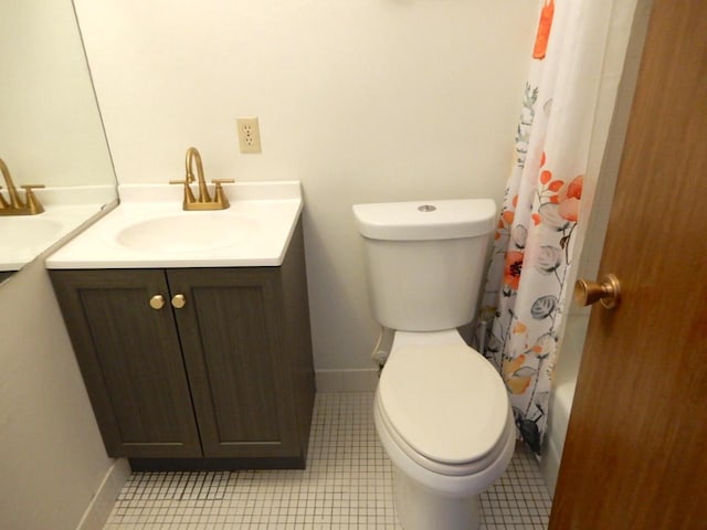 bathroom featuring toilet, vanity, and baseboards
