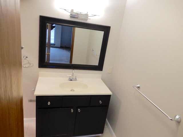 bathroom with baseboards, tile patterned flooring, and vanity