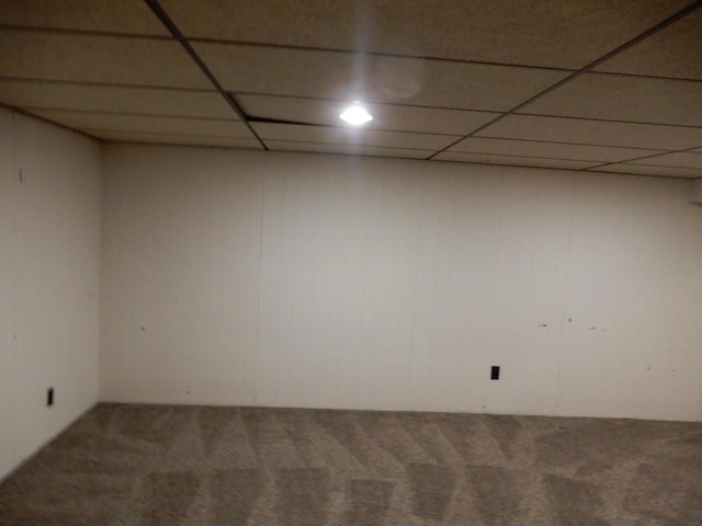 finished basement featuring a drop ceiling and carpet floors