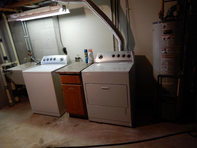 laundry area with independent washer and dryer, concrete block wall, cabinet space, and a sink