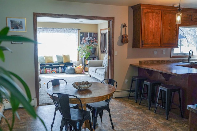 2005 Hollister Ave, Tomah, WI 54660 - dining space with a baseboard radiator, a healthy amount of sunlight, and stone finish floor