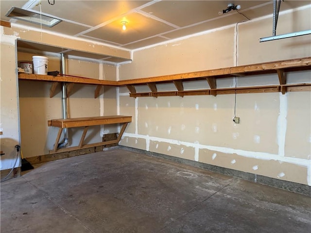 basement with a garage and baseboards
