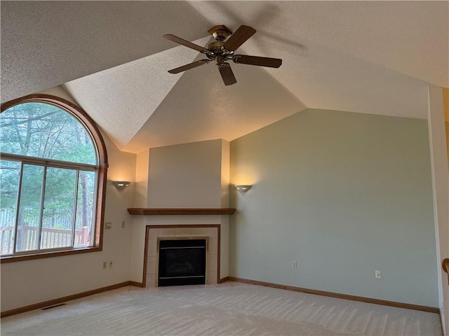 unfurnished living room with a textured ceiling, ceiling fan, vaulted ceiling, and visible vents
