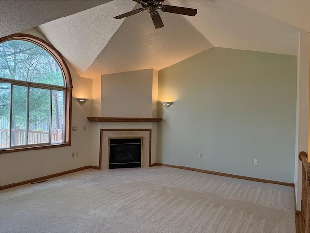 unfurnished living room with a ceiling fan, light colored carpet, visible vents, a fireplace, and vaulted ceiling