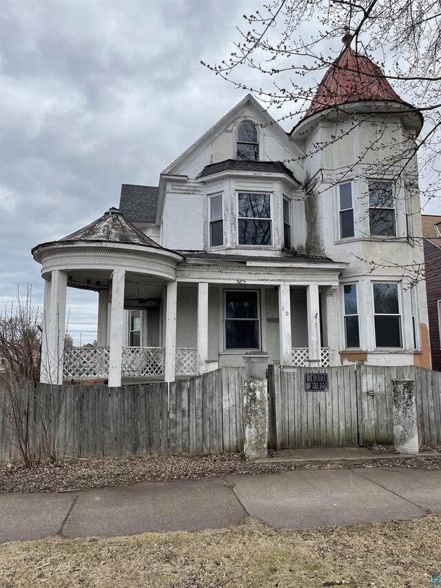 2002 Banks Ave, Superior, WI 54880 - victorian home with a porch and a fenced front yard