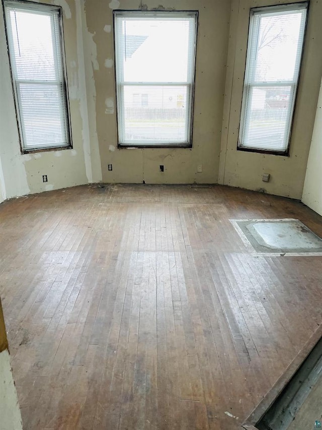2002 Banks Ave, Superior, WI 54880 - spare room featuring hardwood / wood-style floors and a healthy amount of sunlight