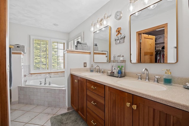 full bath featuring a garden tub, tile patterned flooring, double vanity, and a sink