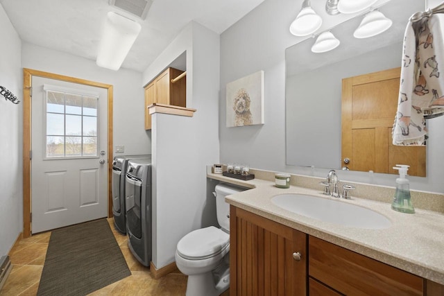 bathroom with visible vents, toilet, washer and clothes dryer, and vanity