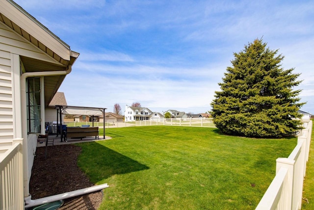 view of yard featuring a patio area, a residential view, and a fenced backyard