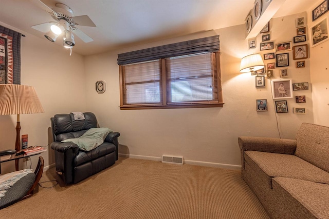sitting room featuring baseboards, visible vents, a ceiling fan, and carpet flooring
