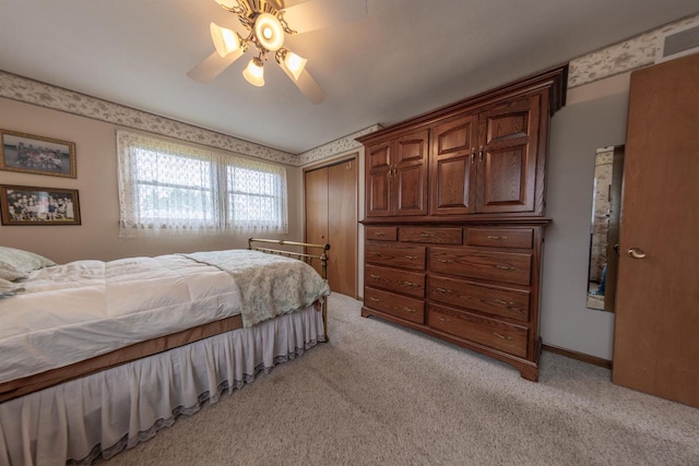 bedroom featuring a closet, ceiling fan, and light colored carpet