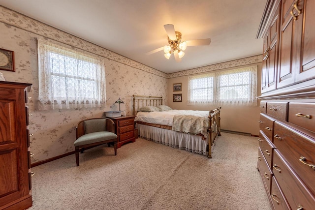 bedroom featuring wallpapered walls and light colored carpet