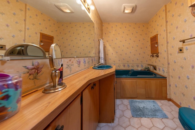 full bathroom with tile patterned floors, wallpapered walls, a garden tub, and vanity