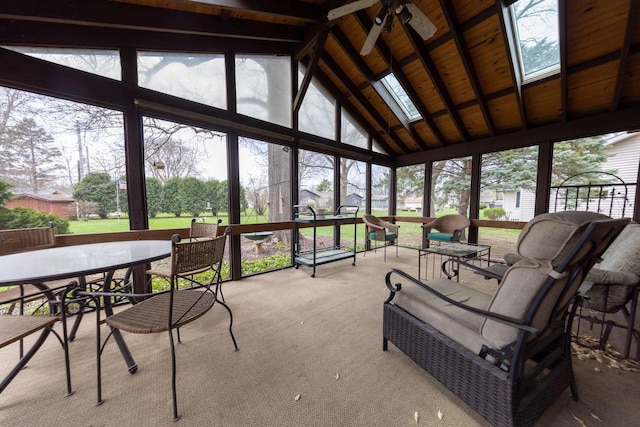 sunroom with a wealth of natural light, a ceiling fan, high vaulted ceiling, and a skylight