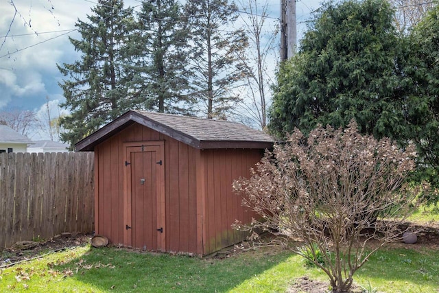 view of shed featuring fence
