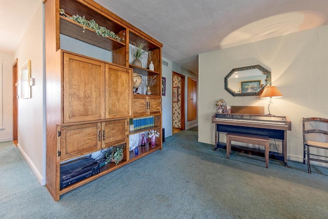 interior space featuring baseboards, visible vents, and carpet flooring